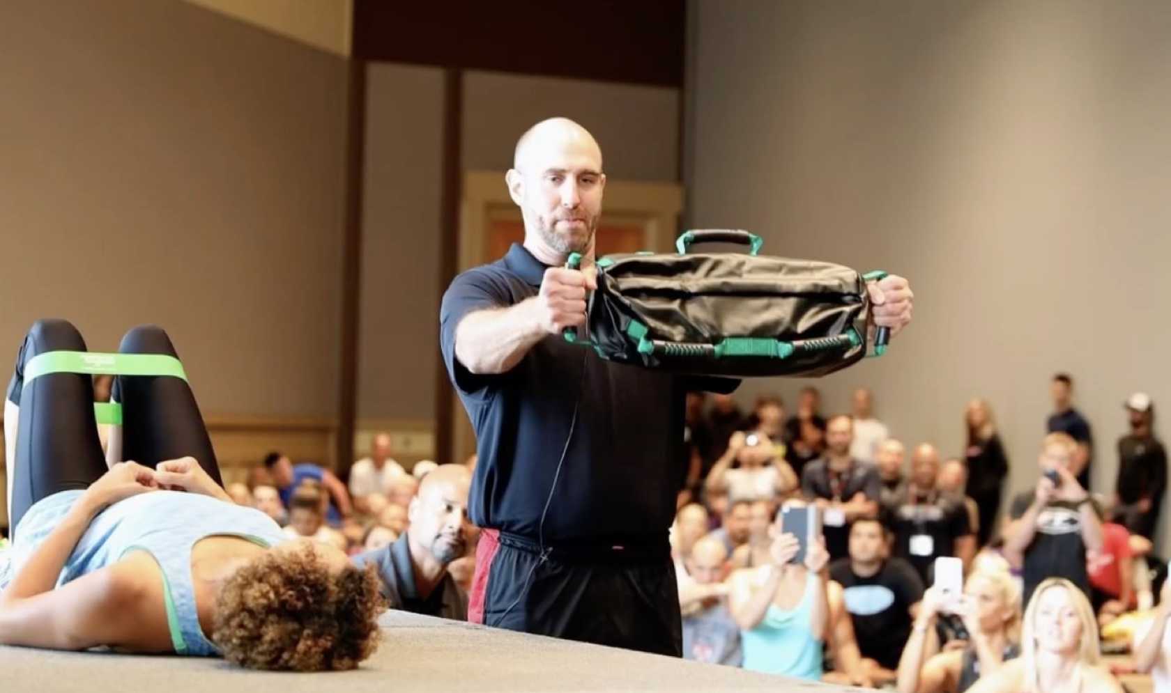 A coach demonstrating a DVRT workshop exercise